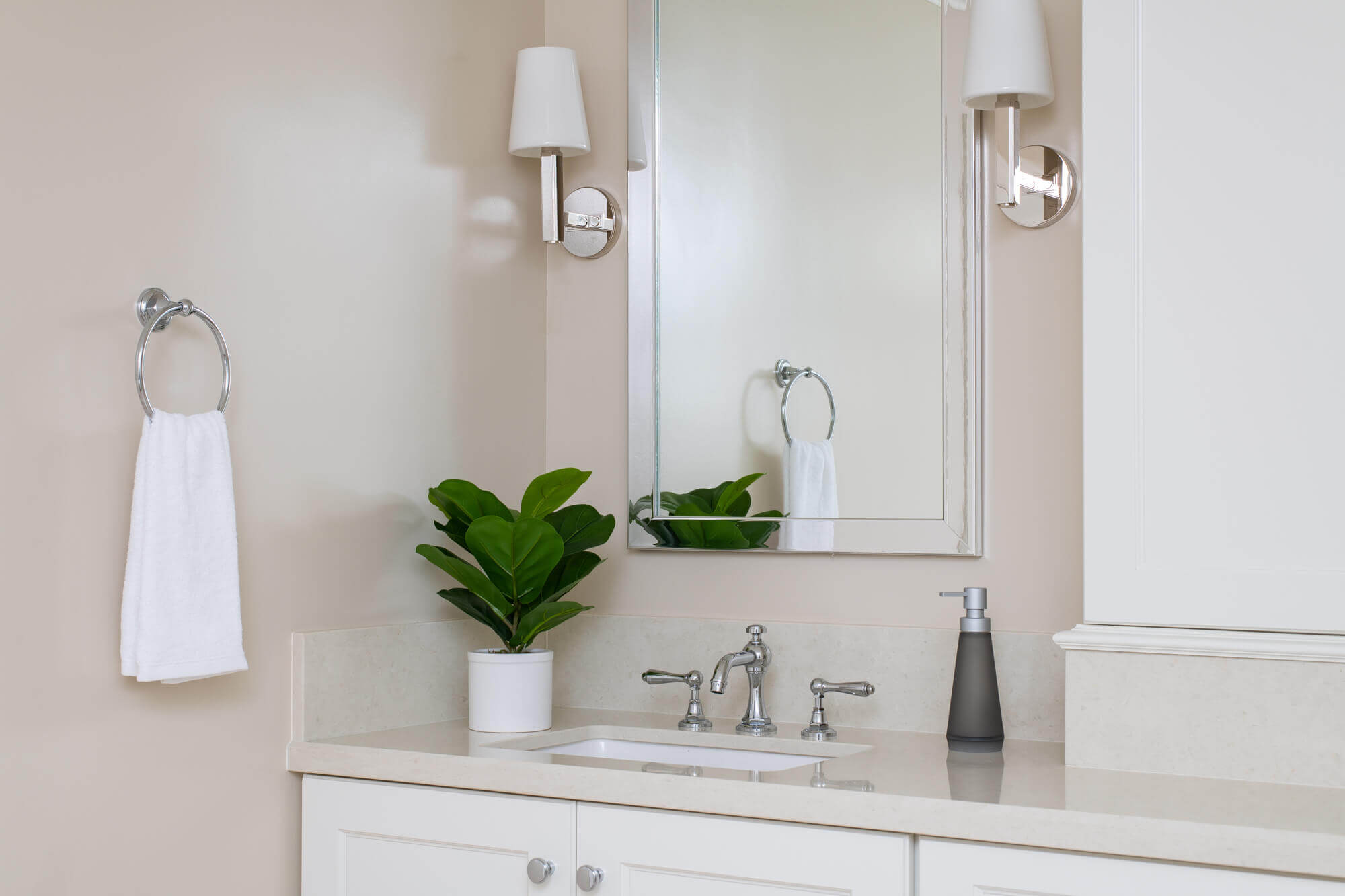 Spacious-kitchen-remodel-withlarge-white-island-andwhite-cabinetry-with-glossy-blue-backsplash