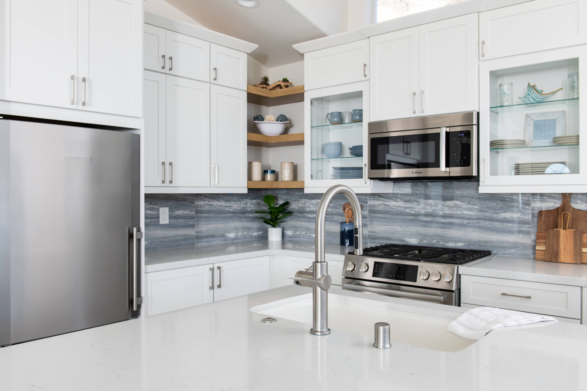 White-cabinetry-in-kitchen-remodel-with-stainless-steel-appliances-creates-bright-transitional-design