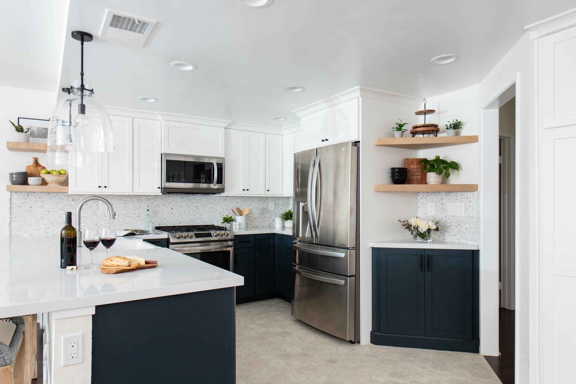 white kitchen cabinets with black appliances