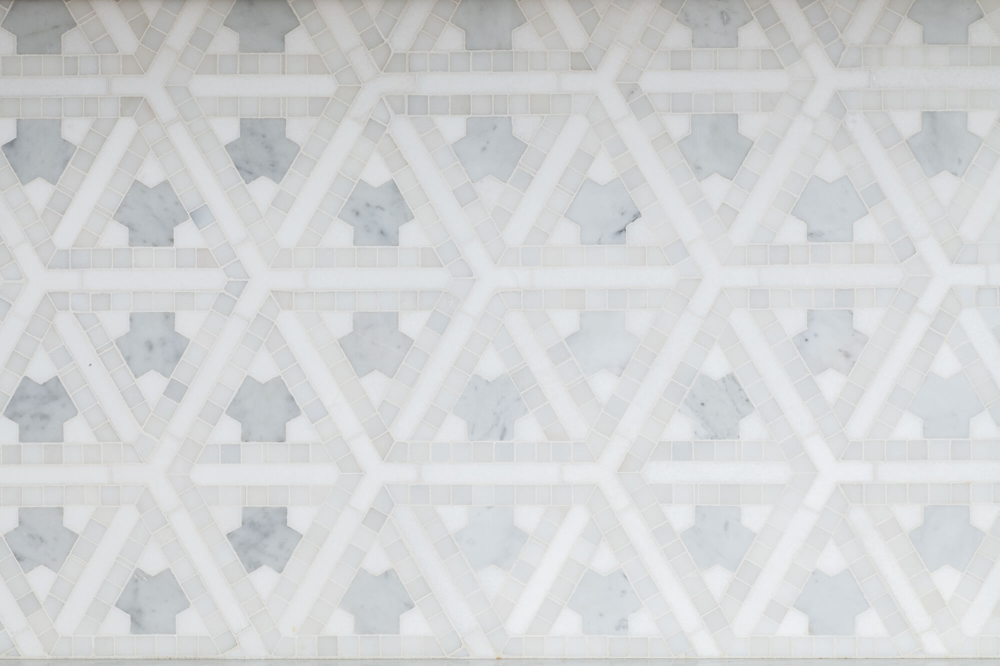 Geometric marble backsplash with water color affect in kitchen remodel