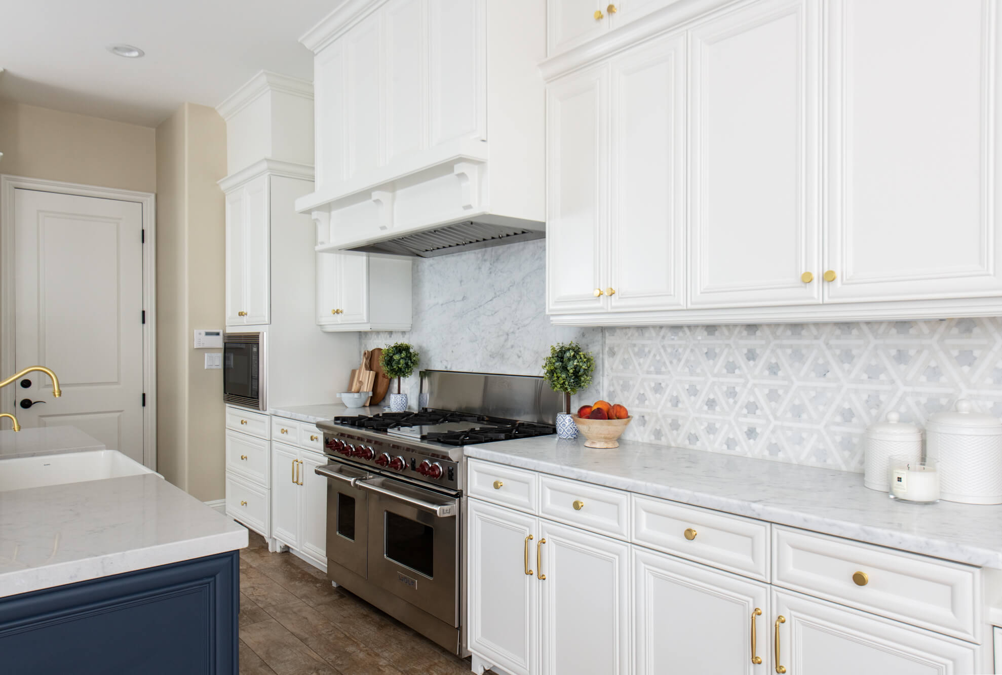 Open Concept Kitchen Remodel With White Cabinetry and Blue Island