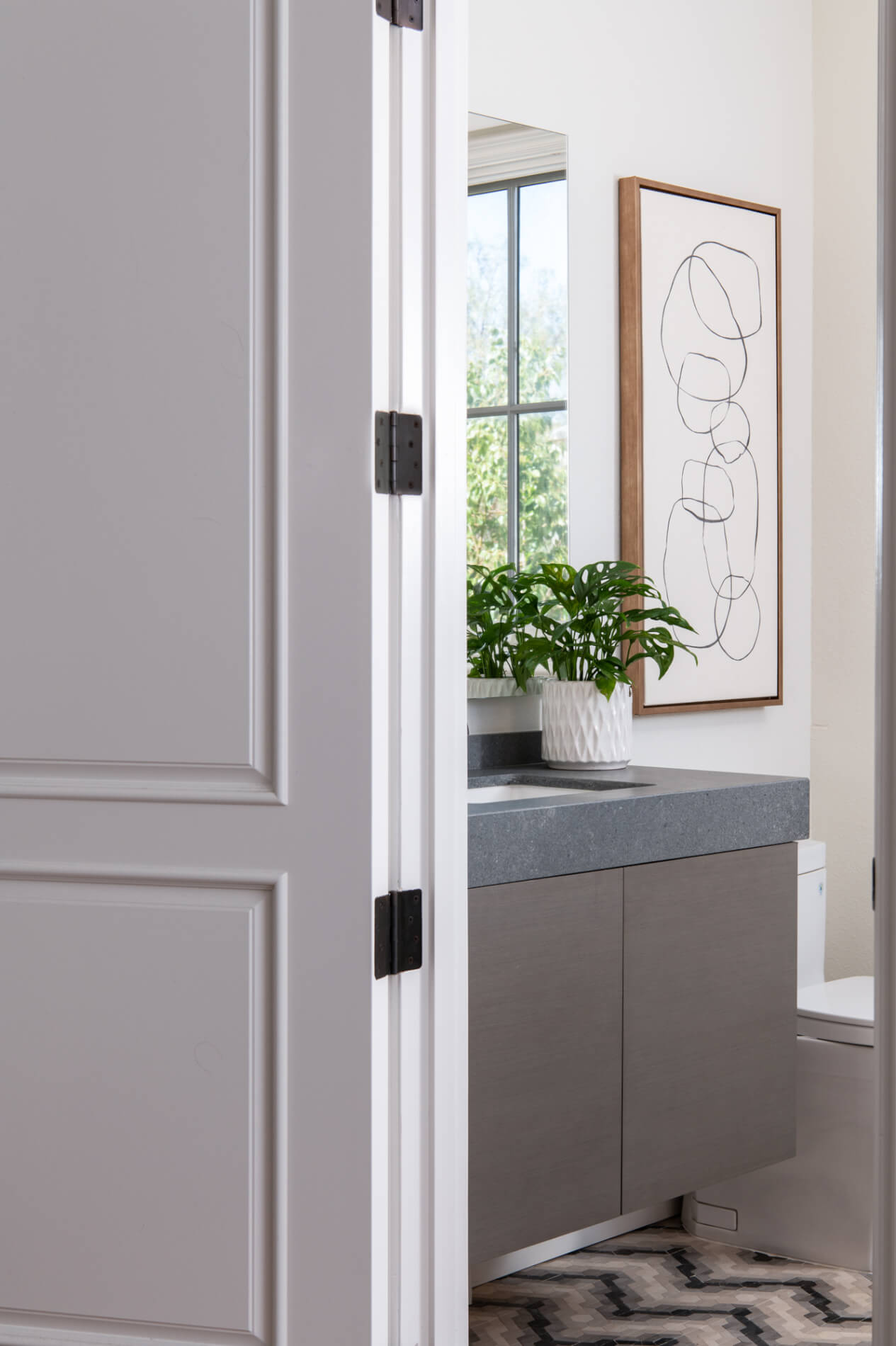 Limestone flooring tile and quartz countertop in bathroom remodel