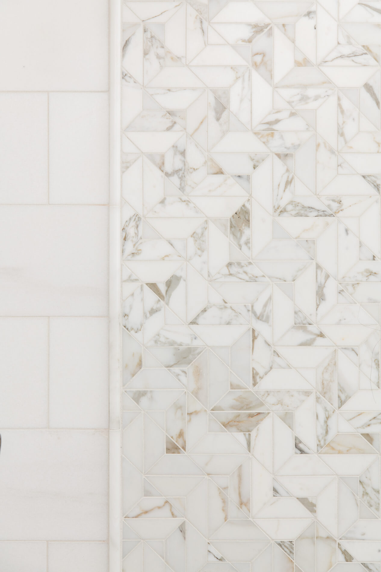 Marble chevron pattern accent design in shower remodel