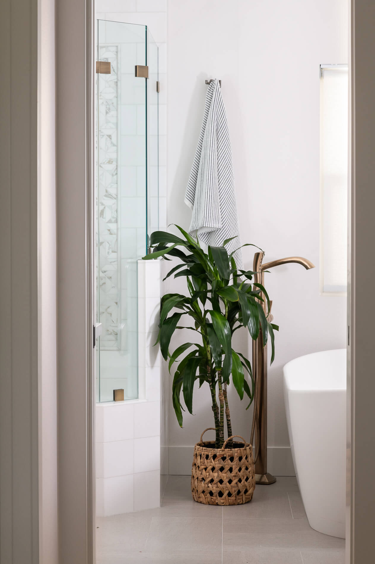 Freestanding tub and greenery in Irvine bathroom remodel