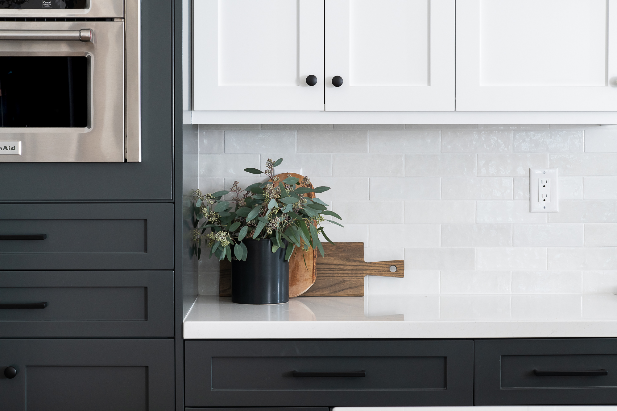 quartz-stone-countertop-custom-grey-and-white-shaker-cabinets-ceramic-backsplash