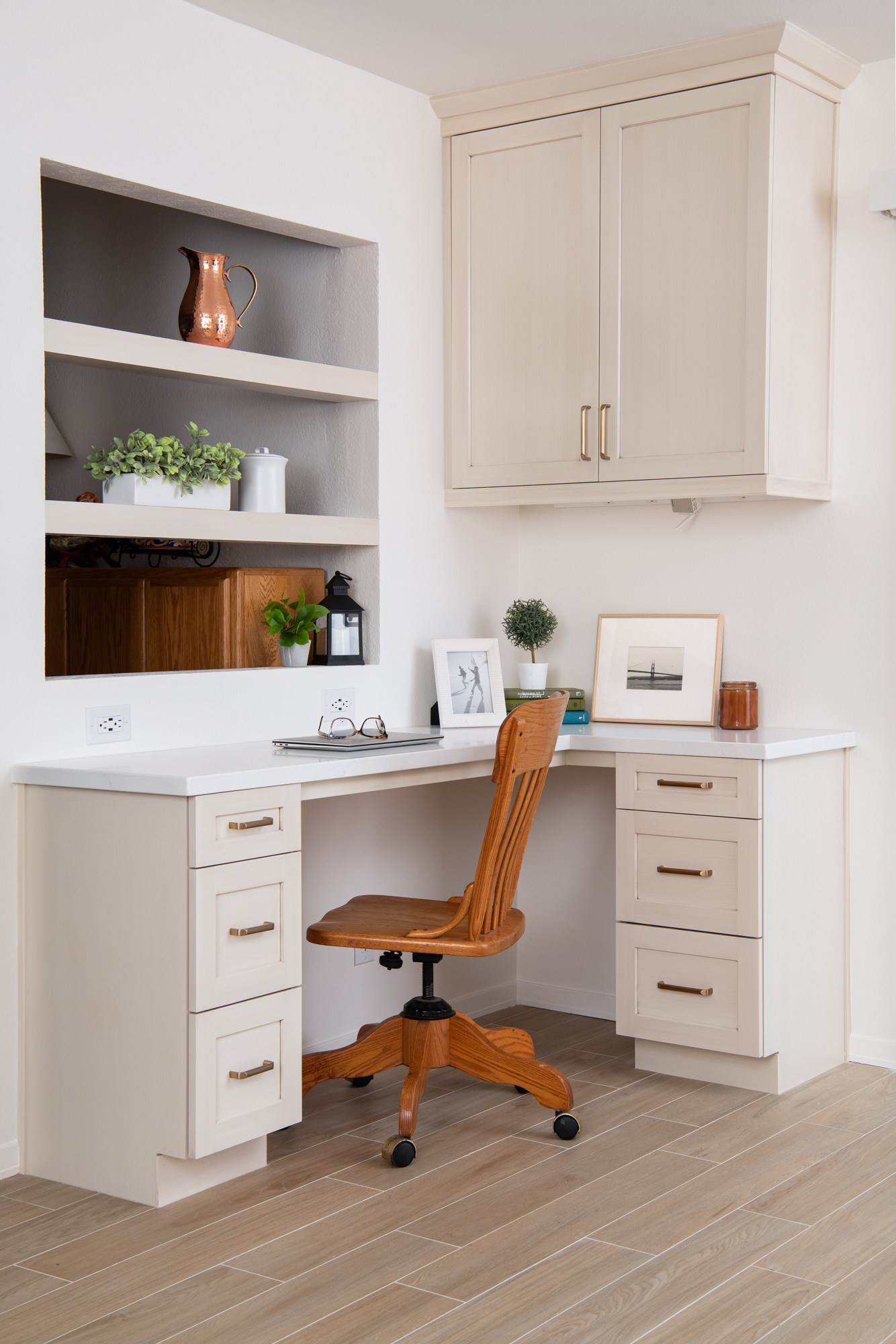 built-in-desk-with-floating-shelf-storage-and-Omega-cabinets-with-honey-bronze-pulls