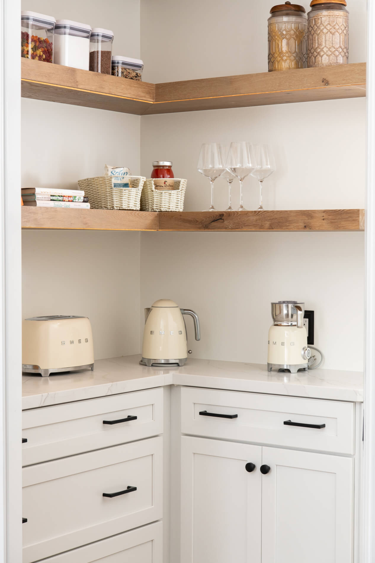 LED-lighting-integrated-into-pantry shelves-above-Omega-pearl-white-maple-cabinets-and-statuario-quarts-counters