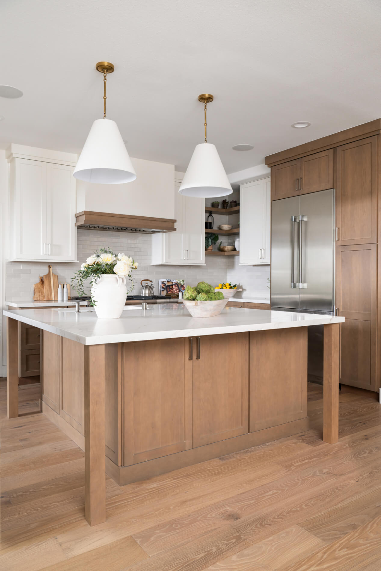 Island-refrigerator-and-lower-cabinetry-framed-in-Omega-Dynasty-Alderwood-in-Riverbed