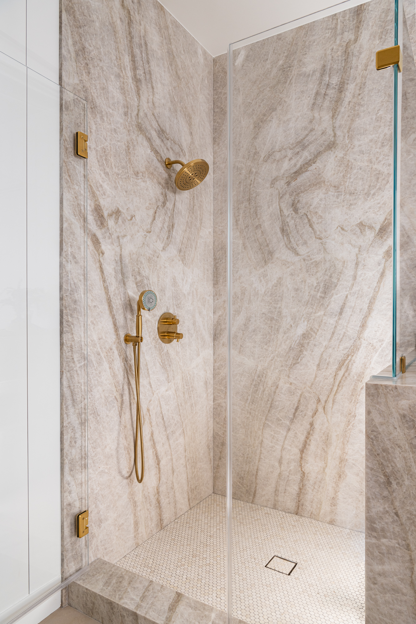 Shower-walls-Quartzite-Slab-Leathered-Taj-Mahal-flooring-Limestone-penny-rounds-oyster-gray-grout