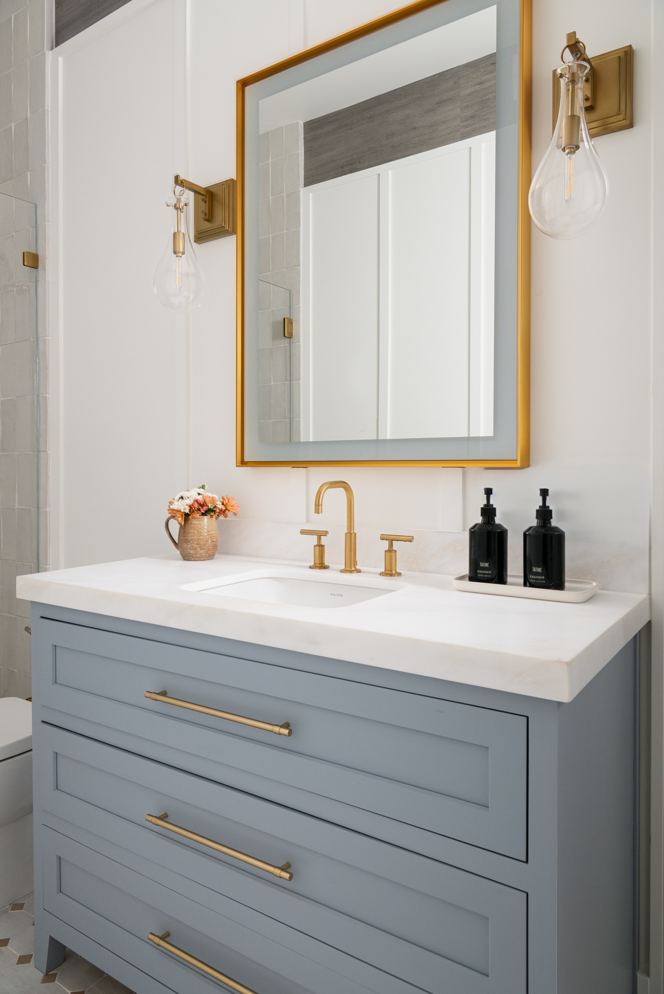 Omega-Framed-Custom-Inset-cabinetry-with-tapered-legs-in-custom-paint-Opaque-Manor-Blue-with-Satin-Finish-and-brushed-modern-brass-drawer-pulls