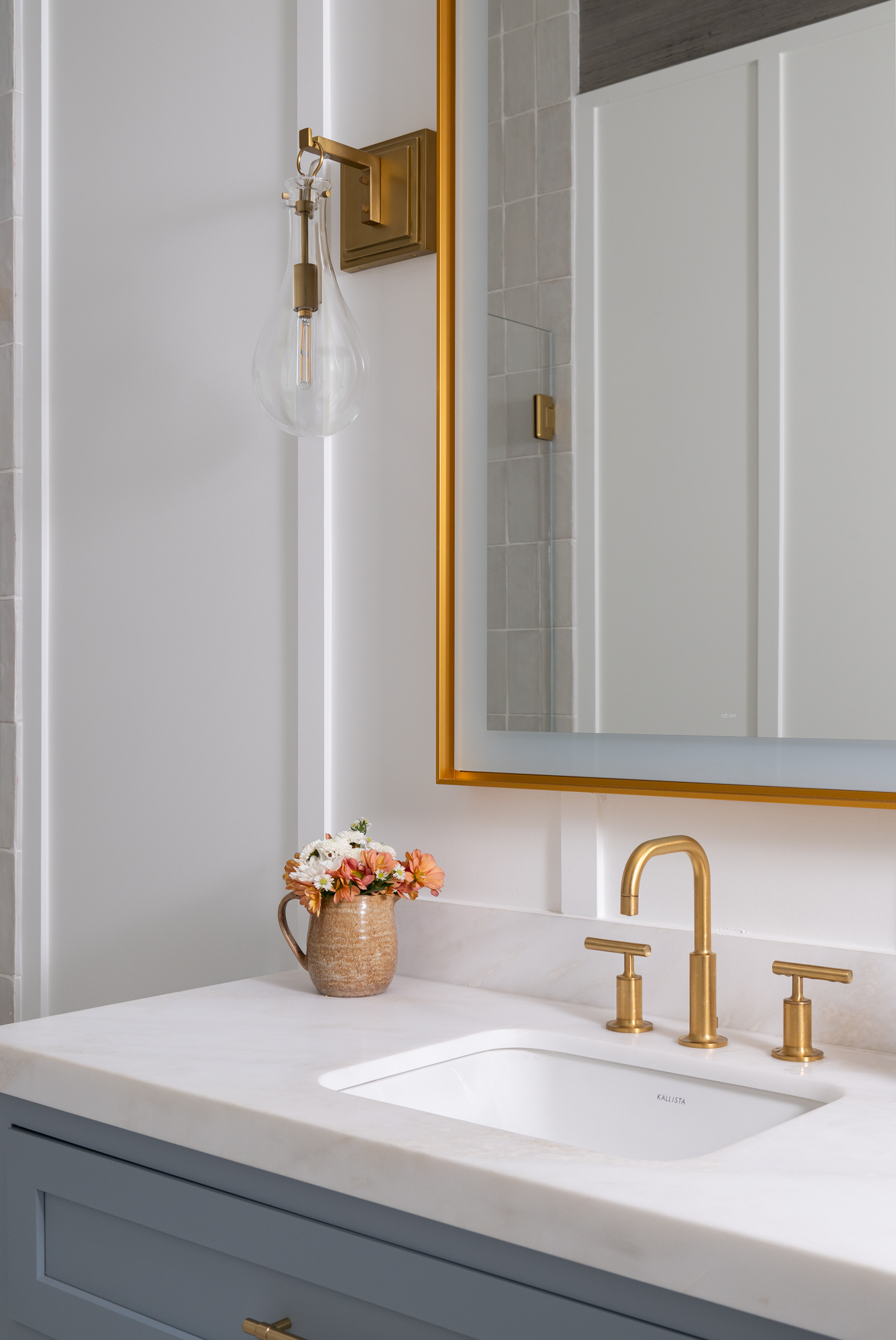 Sky-White-Dolomite-Honed-quartz-countertop-and-shower-curb-with-undermount-sink-and-Vitality-Sculpt-light-up-mirror