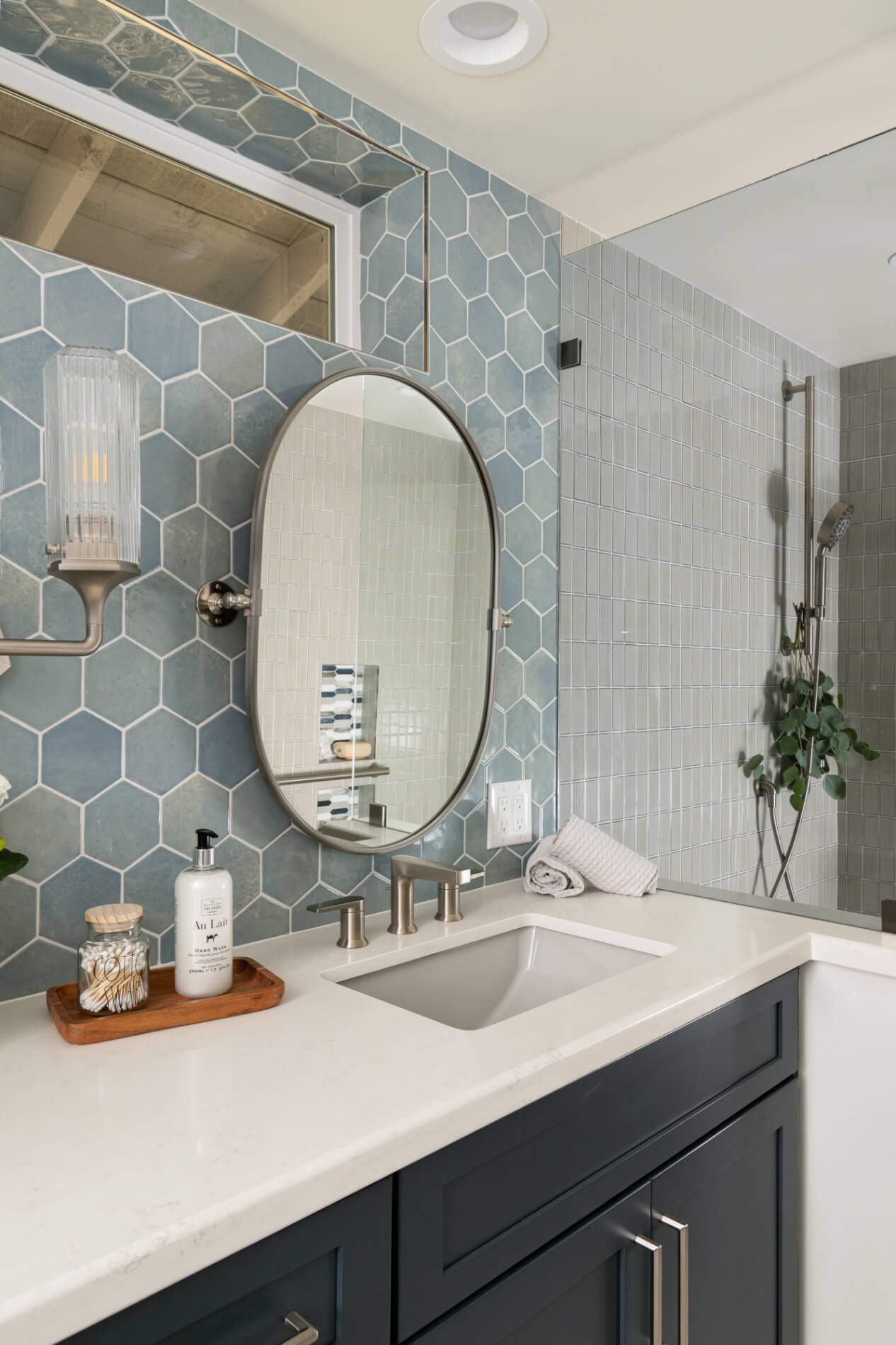 Polished-Quartz-Countertops-by-Vadara-in-Amara-Grey-and-pony-wall-with-spot-resistant-glass-panel-divider