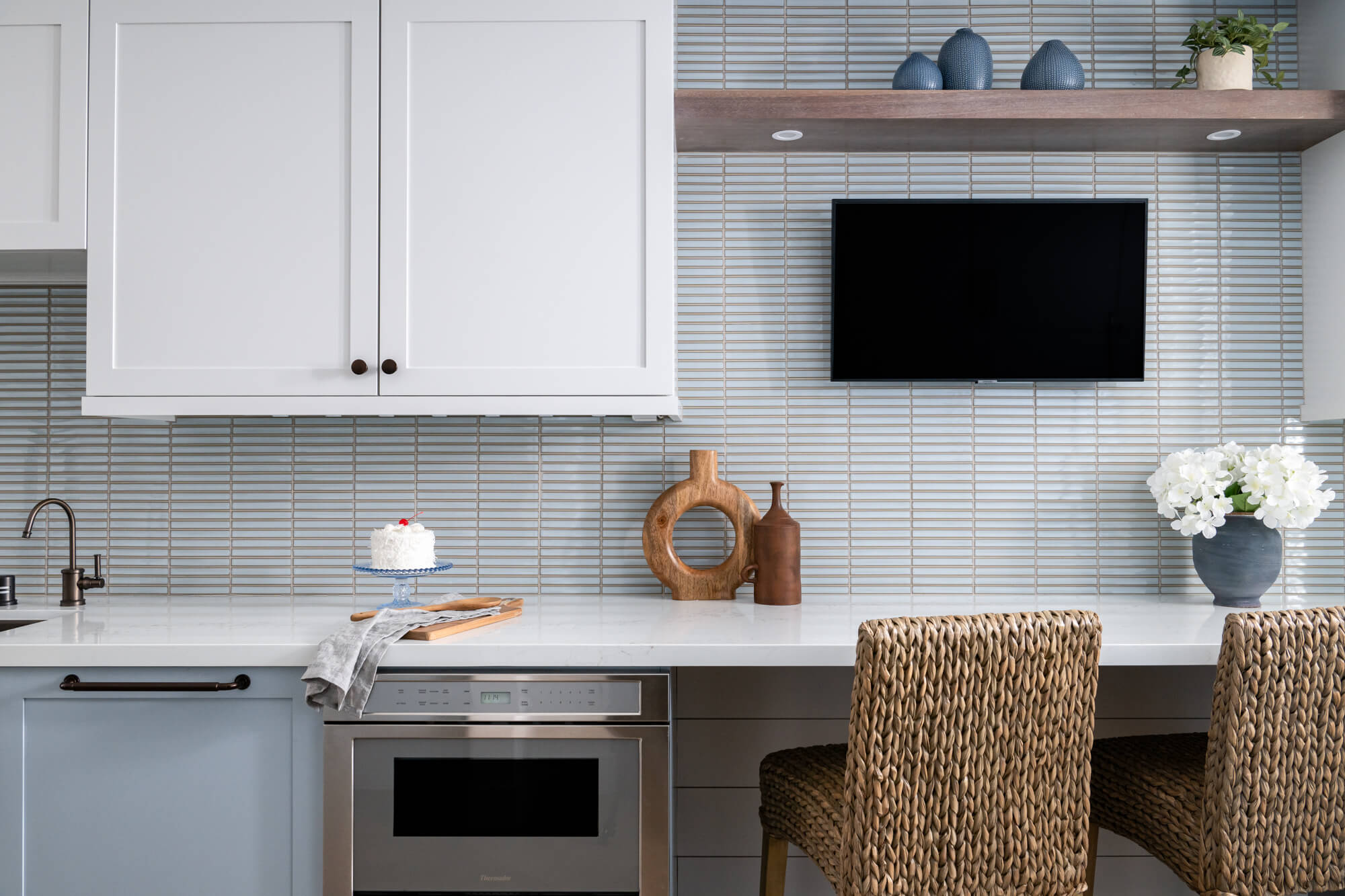 two-Omega-floating-shelves-in-Ceruse-Natural-finish-with-integrated-puck-lighting-and-tv-sit-over-built-in-desk-area