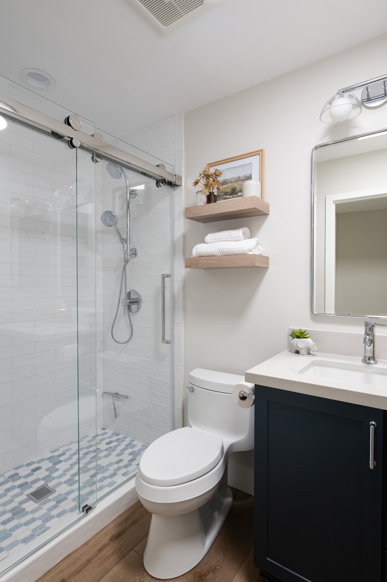 40-sq-ft-guest-bathroom-remodel-with-natural-wood-floating-shelves-recessed-mirrored-medicine-cabinet-LVP-flooring-in-Albright