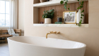 freestanding-tub-with-wall-mounted-faucet-in-aged-brass