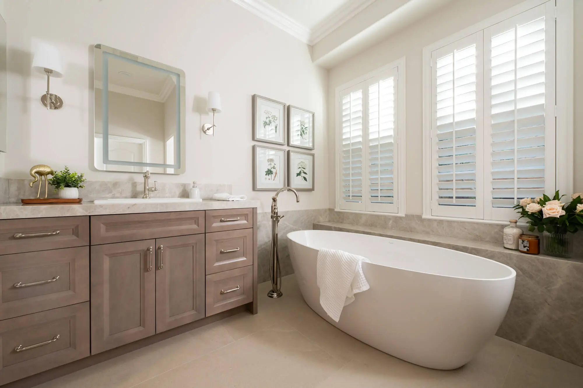 2025 bathroom remodeling trends include tile accents behind a freestanding tub