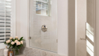 zero-threshold-shower-entrance-with-pony-wall-with-custom-glass-panel-window