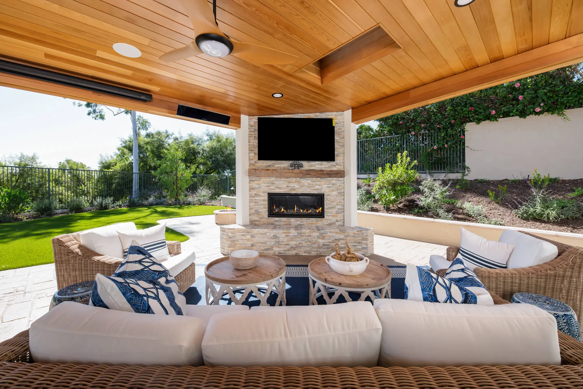 This Rancho Santa Margarita California Room features ceiling fans and a fireplace for comfort in any weather.