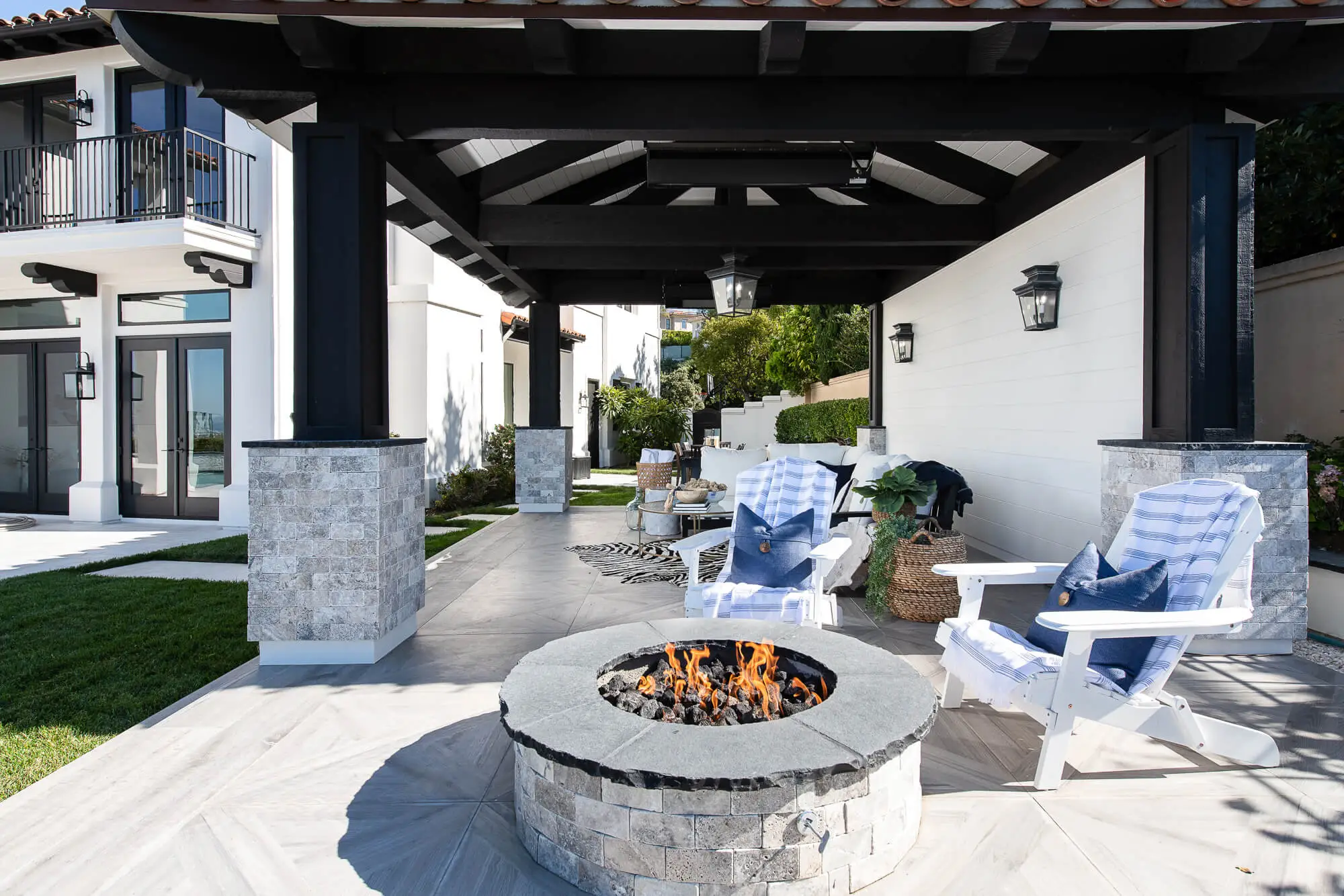 This outdoor living space features a fire pit with an ocean view.