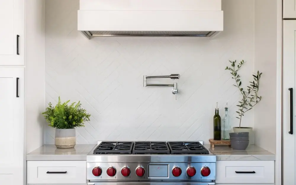Diagonal subway tile backsplash behind range
