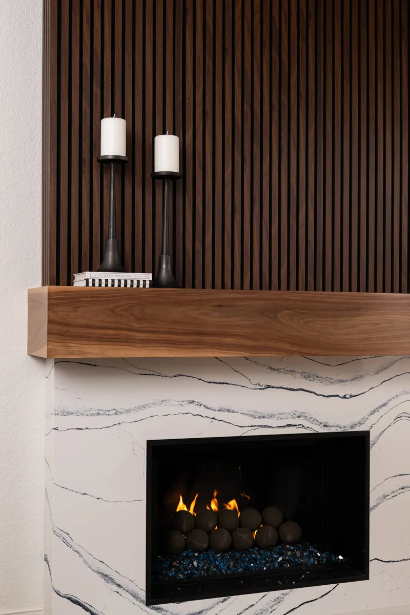 sea-pointe-design-and-remodel-fireplace-hearth-and-surround-in-polished-quartz-Portrush-finish-and-a-walnut-mantel