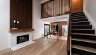 sea-pointe-design-and-remodel-framed-in-2x4-walnut-slatted-wall-at-catwalk-with-furniture-finish-to-match-stair-handrails-and-fireplace