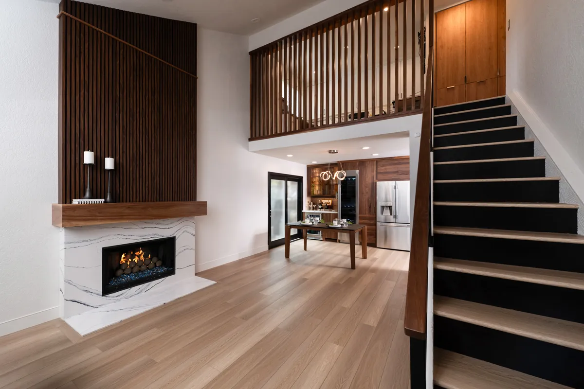 sea-pointe-design-and-remodel-framed-in-2x4-walnut-slatted-wall-at-catwalk-with-furniture-finish-to-match-stair-handrails-and-fireplace