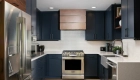 sea-pointe-design-and-remodel-featuring-Waypoint-Maple-cabinetry-in-Painted-Navy-with-shaker-cabinets-with-hidden-undercabinet-power-strips
