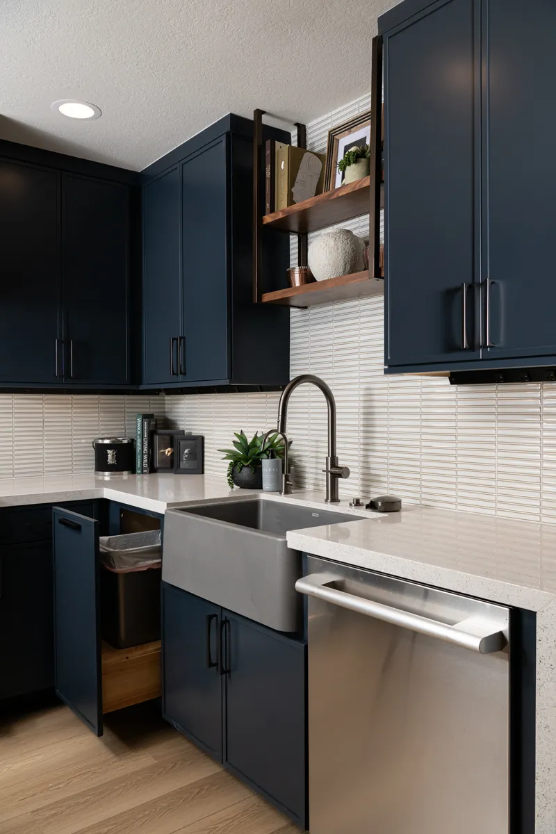 sea-pointe-design-and-remodel-trash-bin-located-in-cabinetry-next-to-sink-and-walnut-shelf-unit-with-dark-bronze-finish-mounted-to-ceiling-above-sink