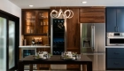 sea-pointe-design-and-remodel-bar-area-features-an-under-counter-ice-maker-with-wood-paneling-and-integrated-column-wine-refrigerator