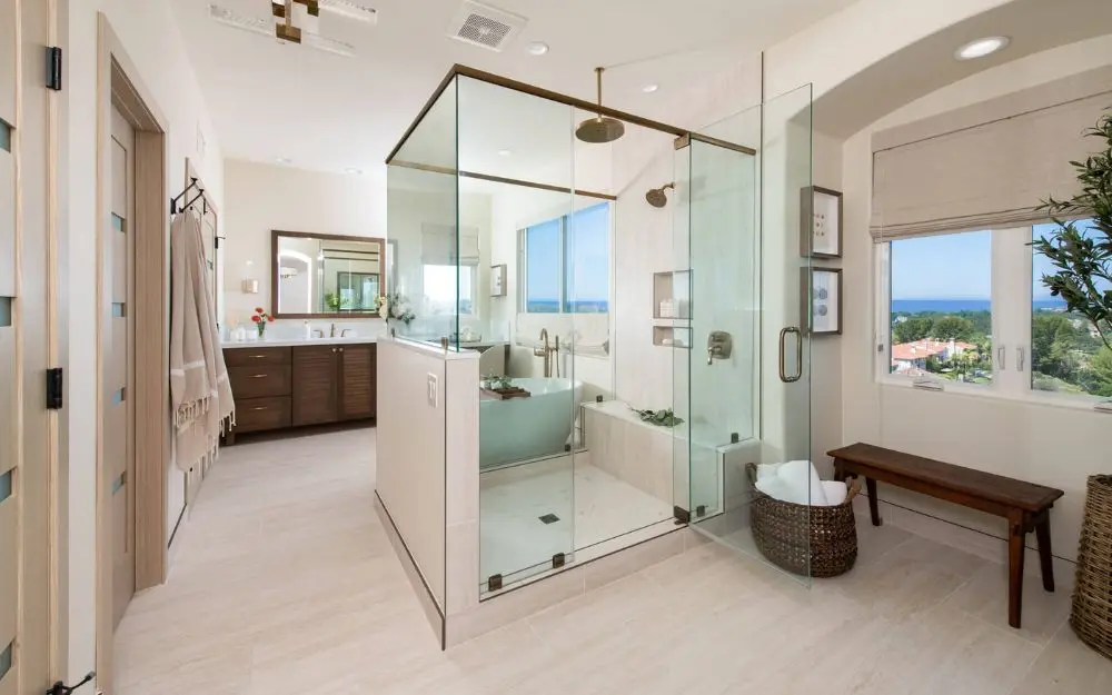 Expansive Newport Coast master bathroom remodel with dual vanities, walk in shower, and freestanding tub - bathroom design trends