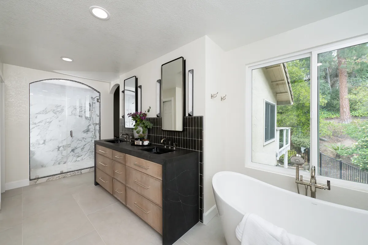 sea-pointe-design-and-remodel-arched-shower-entrance-featuring-Bedrosians-Celine-series-in-Matte-Black-and-custom-glass-shower-enclosure-with-polished-nickel-handle