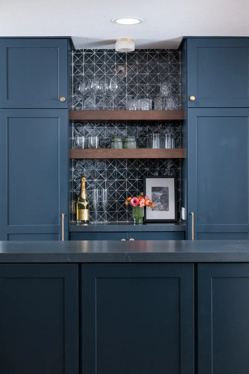 16-Sea-Pointe-Design-and-Remodel-Kemper-cabinetry-in-Maritime-finish-with-cherry-wood-floating-shelves-in-Kanga