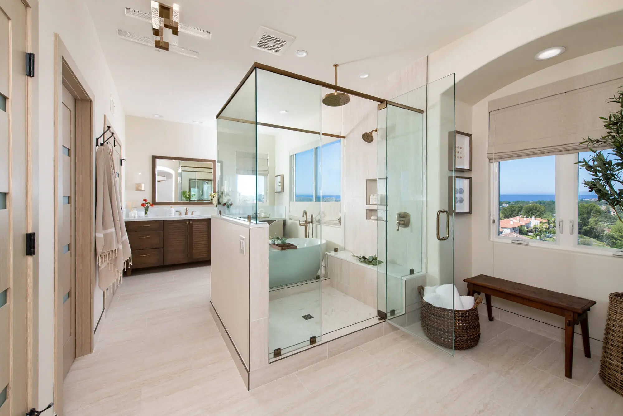 Expansive Newport Coast master bathroom remodel with dual vanities, walk in shower, and freestanding tub - bathroom design trends