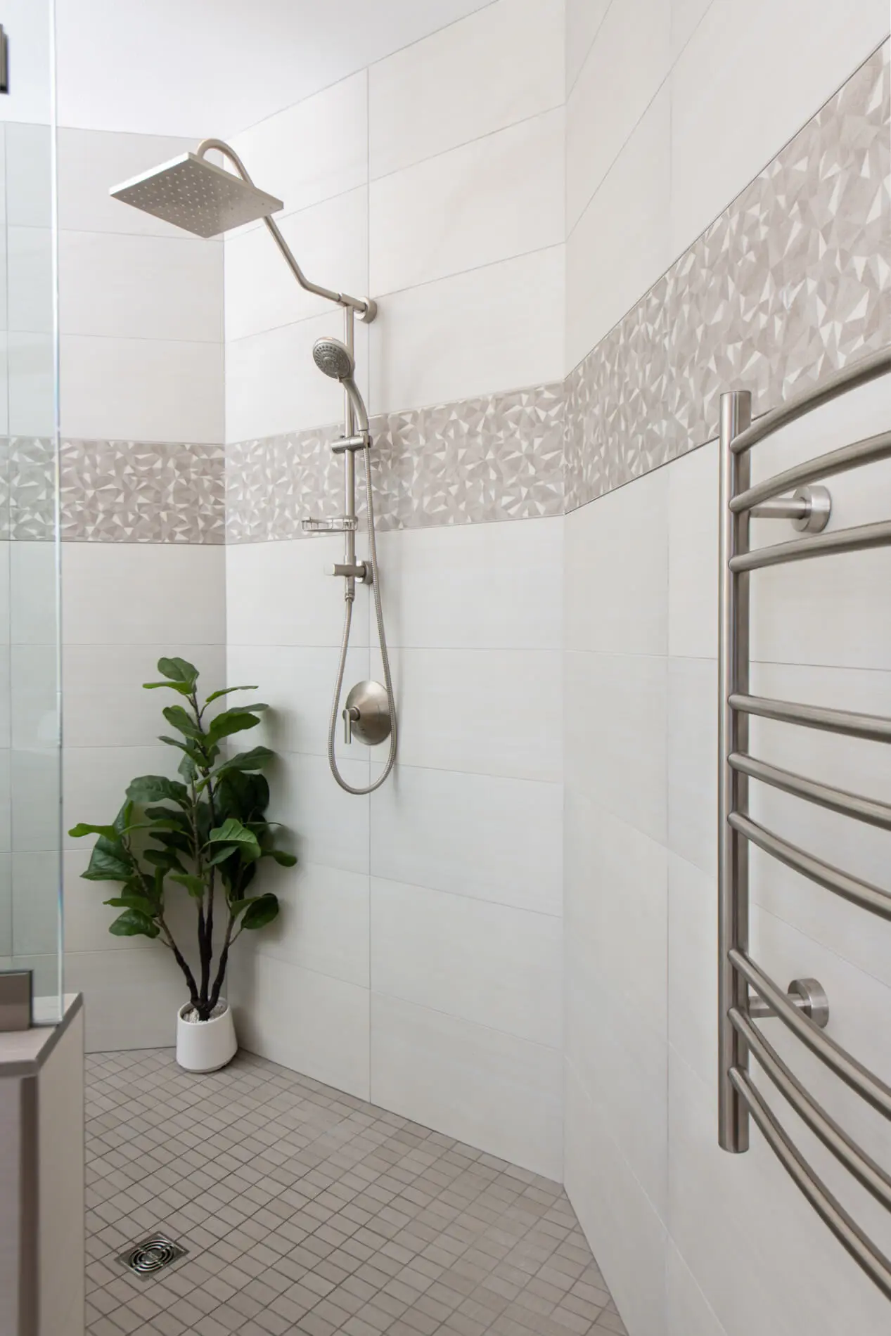 Rainfall fixture and geometric tile design in Mission Viejo bathroom remodel