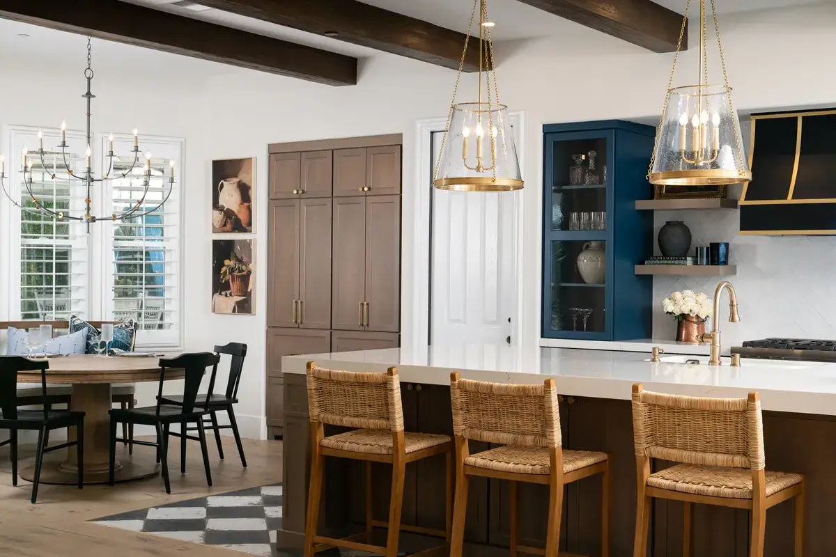 Sea-Pointe-Design-and-Remodel-three-Brushed-modern-brass-pendants-with-fluted-glass-sit-above-the-island