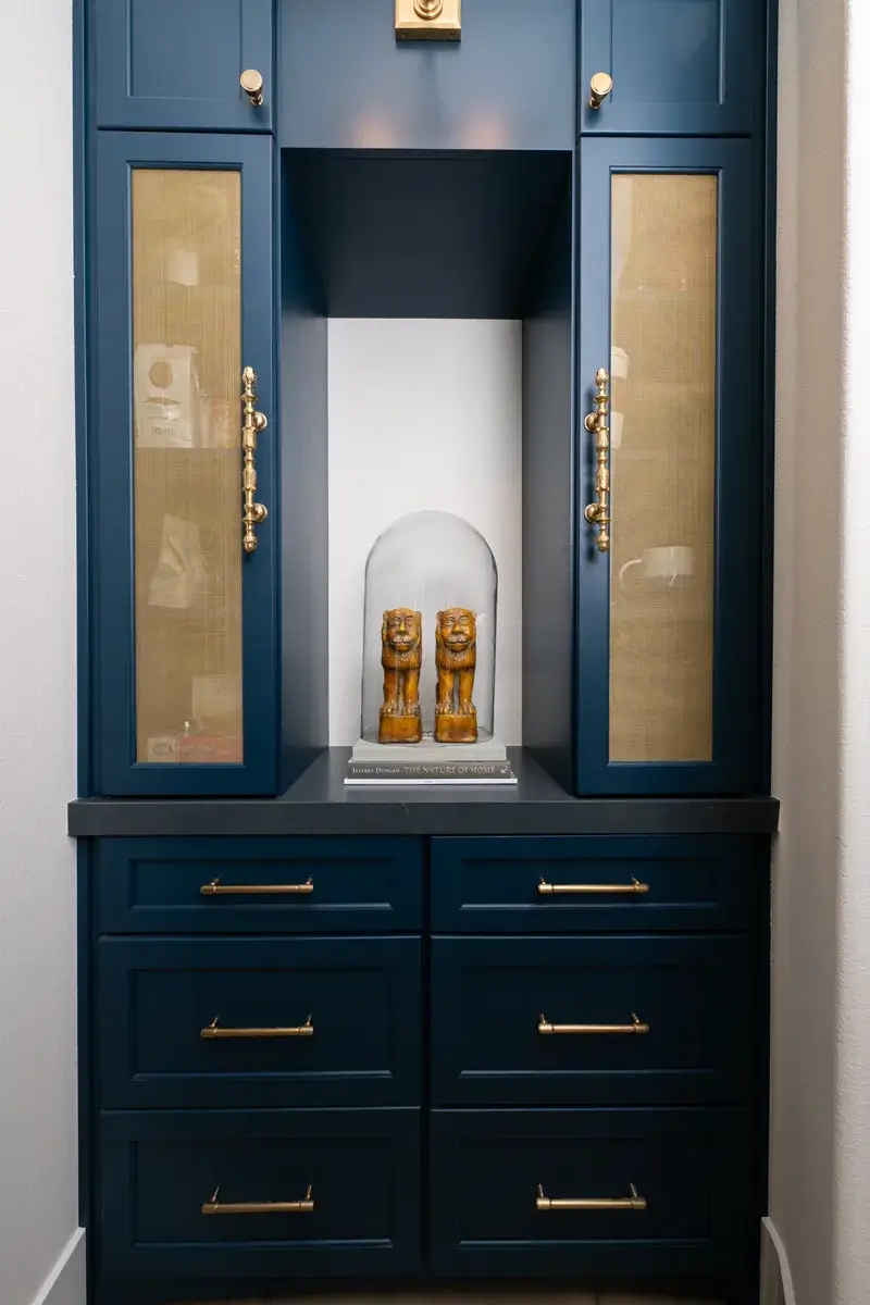 Sea-Pointe-Design-and-Remodel-coffee-bar-with-glass-inserts-and-satin-brass-mesh-grills-in-custom-blue-Omega-cabinetry