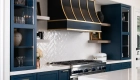 Sea-Pointe-Design-and-Remodel-black-sloped-hood-with-brass-straps
