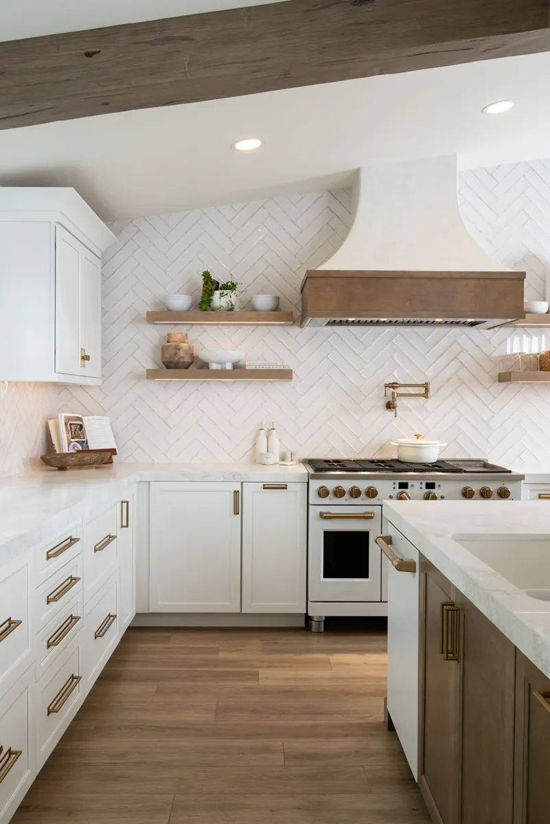 sea-pointe-design-and-remodel-slide-in-range-with-Luxe-gold-wall-mounted-pot-filler