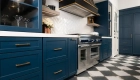 Sea-Pointe-Design-and-Remodel-perimeter-and-coffee-bar-shaker-cabinetry-by-Omega-in-a-custom-blue-with-honey-bronze-pulls