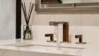 Sea-Pointe-Design-And-Remodel-white-undermount-sink-luxe-nickel-and-wood-widespread-bathroom-faucet