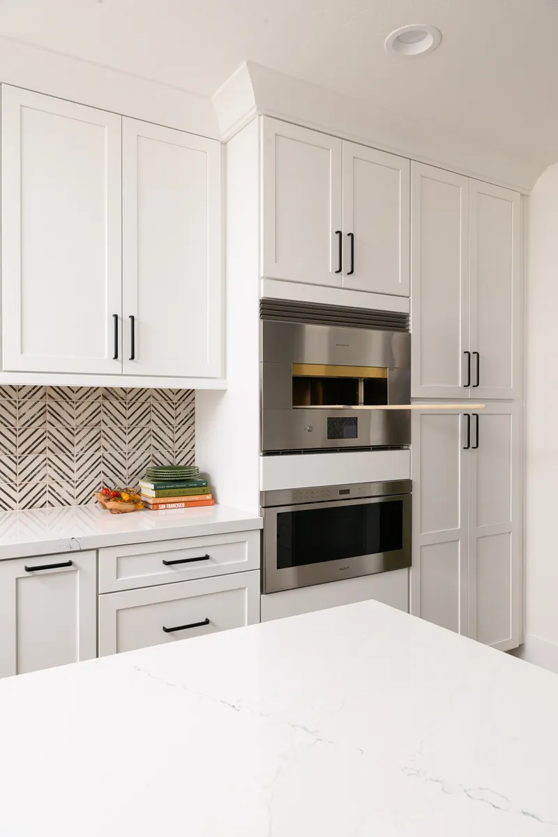 sea-pointe-design-and-remodel-stainless-steel-appliances-including-gas-range-pizza-oven-built-in-microwave-dishwasher-beverage-refrigerator-and-white-fridge-and-freezer