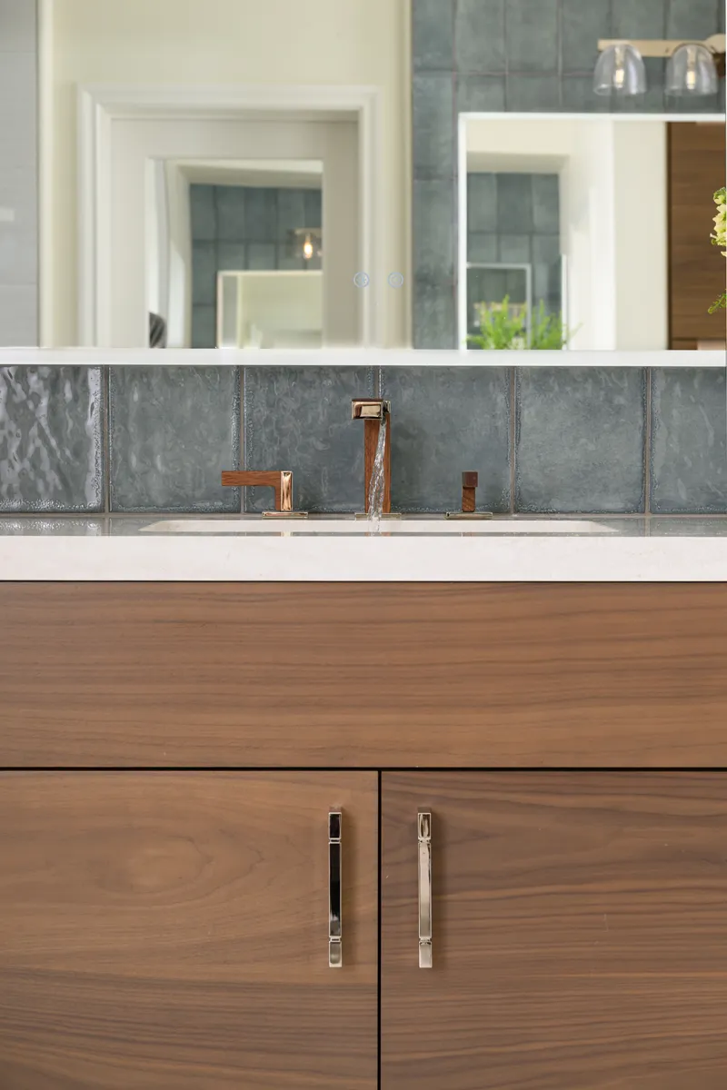 polished-nickel-vanity-cabinet-pulls-and-a-light-sconce-in-polished-nickel-with-clear-glass-covers