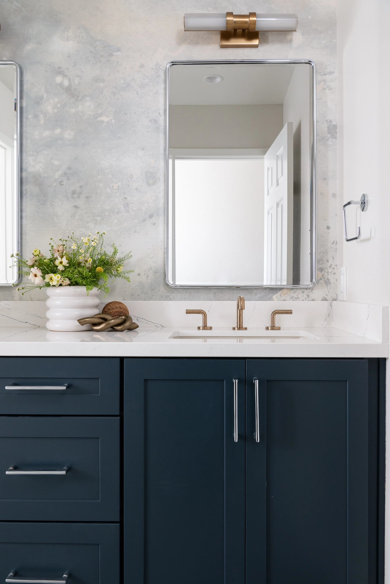Bold wallpaper behind mirrors or vanities is a 2026 bathroom trend that makes a visual impact