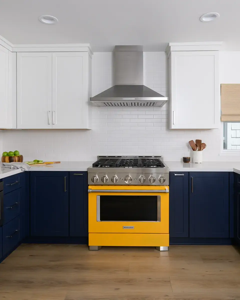 vibrant-yellow-slide-in-gas-range-sits-below-stainless-steel-vent-hood