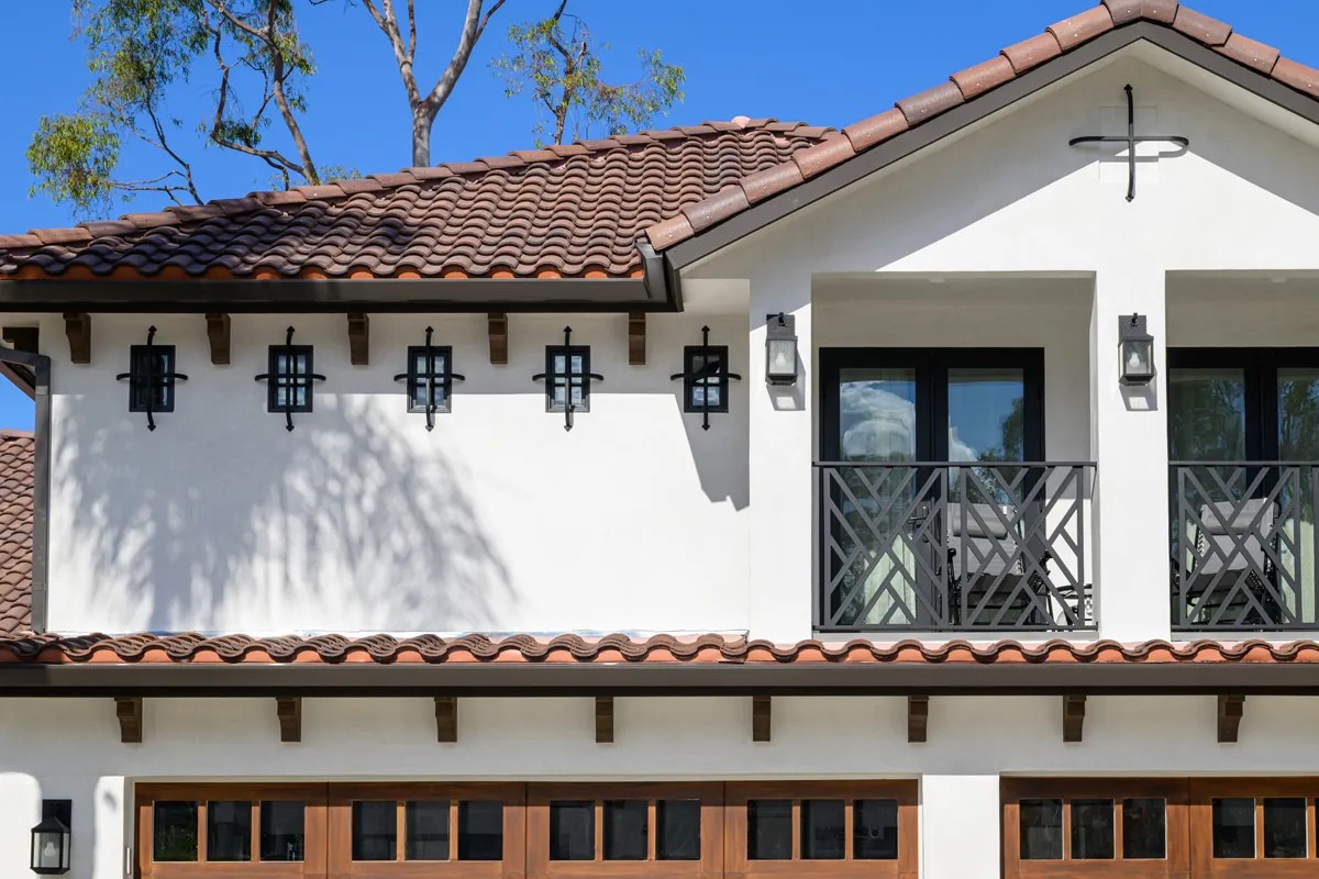 Primary-bedroom-extension-includes-a-new-balcony-with-custom-wrought-iron-accents-and-hooks-and-lattice-cross-window-accents-on-5-windows