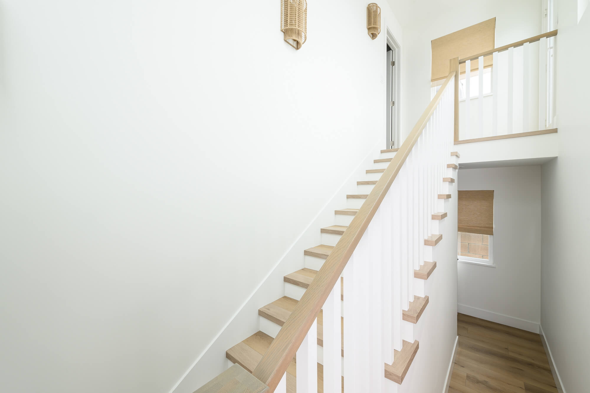 new-staircase-with-open-treads-square-balasters-square-poplar-newell-posts-and-square-edge-handrails-extend-over-catwalk-at-upper-landing