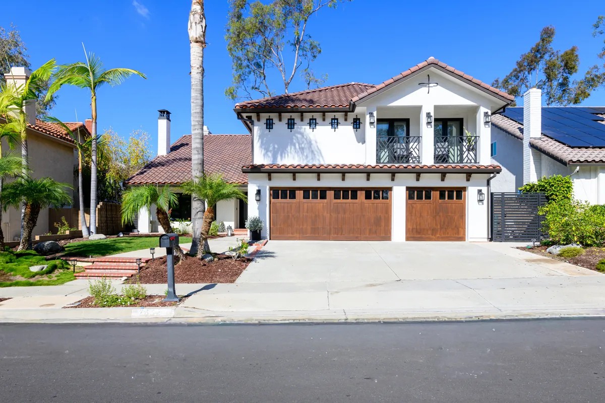 an-addition-that-includes-new-concrete-masonry-corbels-garage-doors-gutters-roofing-deck-coating-stucco-and-siding