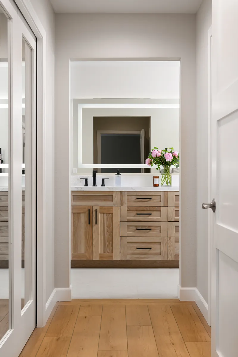 Primary-bathroom-remodel-including-newly-constructed-his-and-hers-closets-with-Calypso-Oak-LVP-flooring