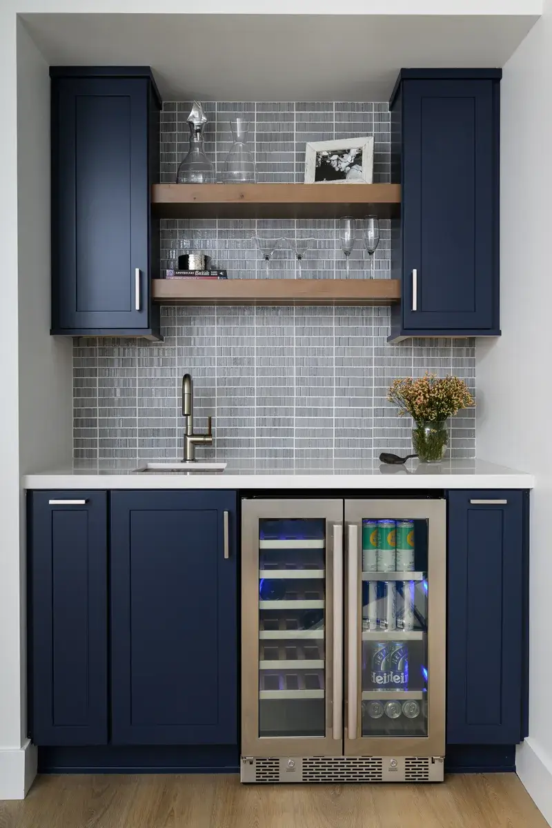 beverage-bar-cabinetry-matches-the-kitchen-and-includes-a-sink-and-beverage-fridge-plus-floating-shelves-to-add-aesthetic-appeal